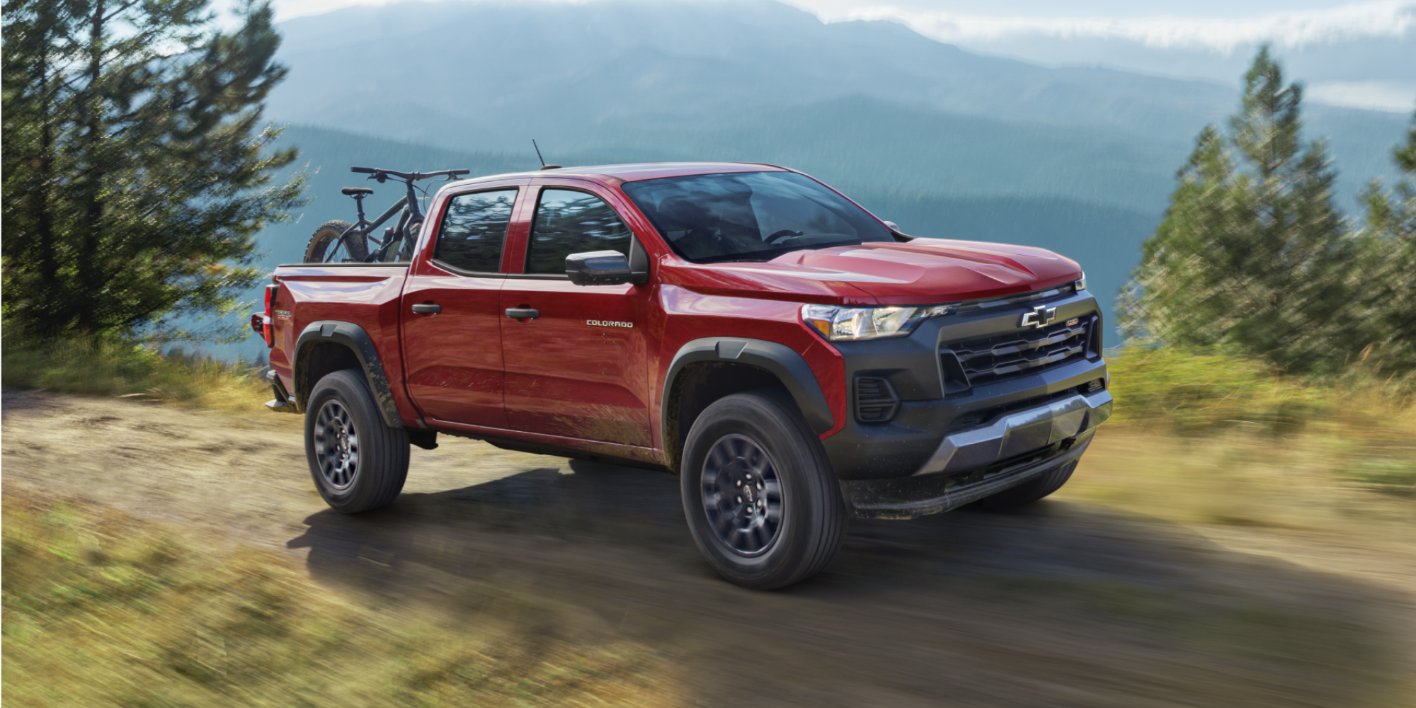 Colorado Trail Boss Driving in the Mountains with Bicycles Stored in the Truck Bed