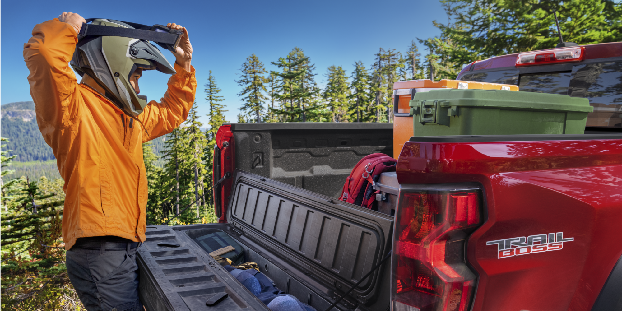A Biker Taking His Equipment Out of the Bed of the Colorado Trail Boss