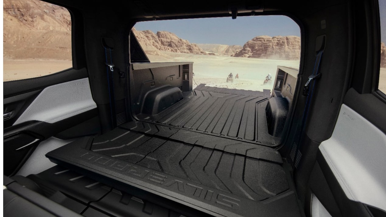 A view out the back of a Silverado EV with the midgate and tailgate both open, showing how much space is created for cargo.