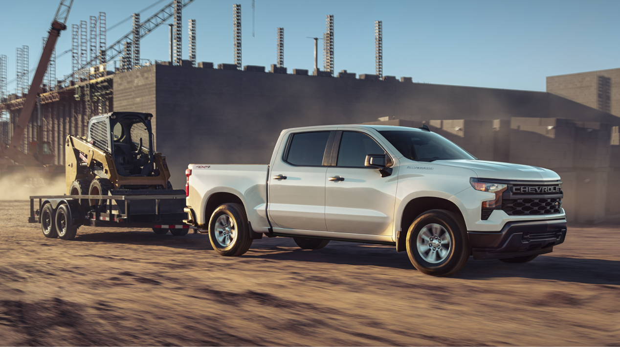 Chevrolet Silverado Towing Construction Equipment on a Work Site