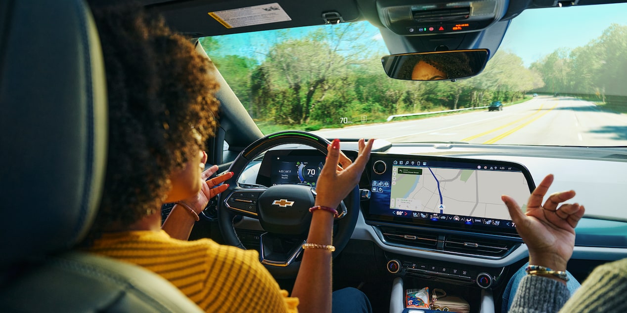 Woman Using Super Cruise Hands Free Driving Feature