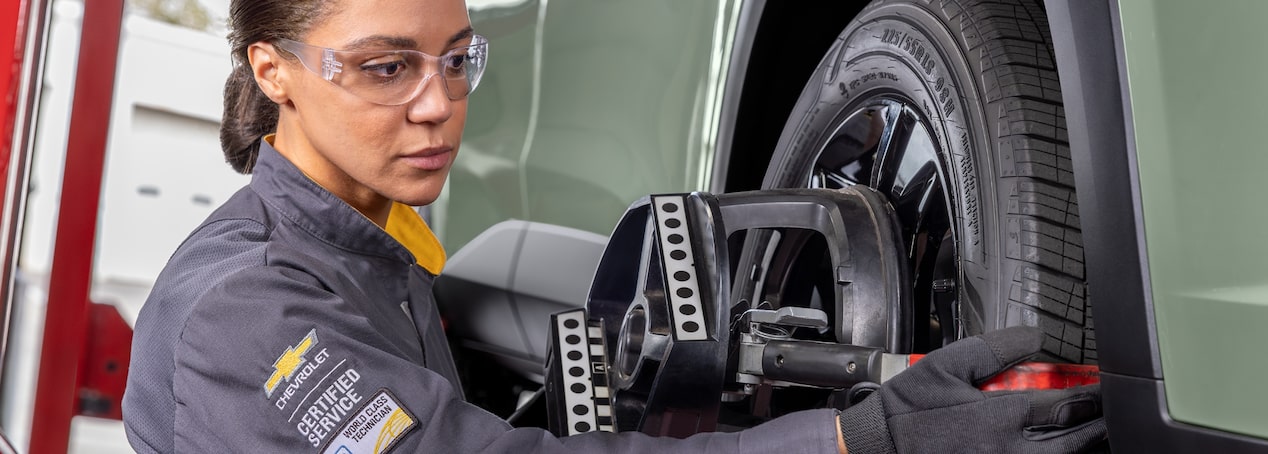 Female Technician inspecting Tire