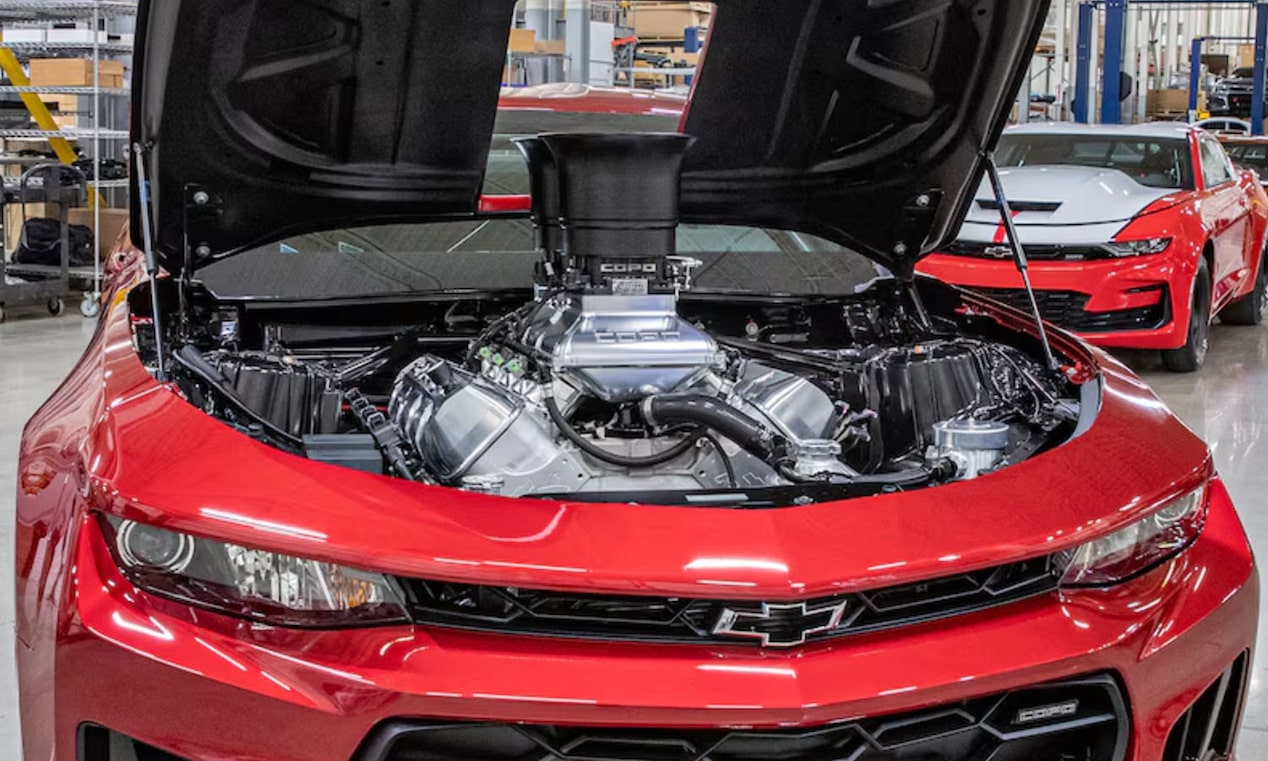 Front View of a Red Chevrolet Car with an Open Hood and a Visible LS3 Engine