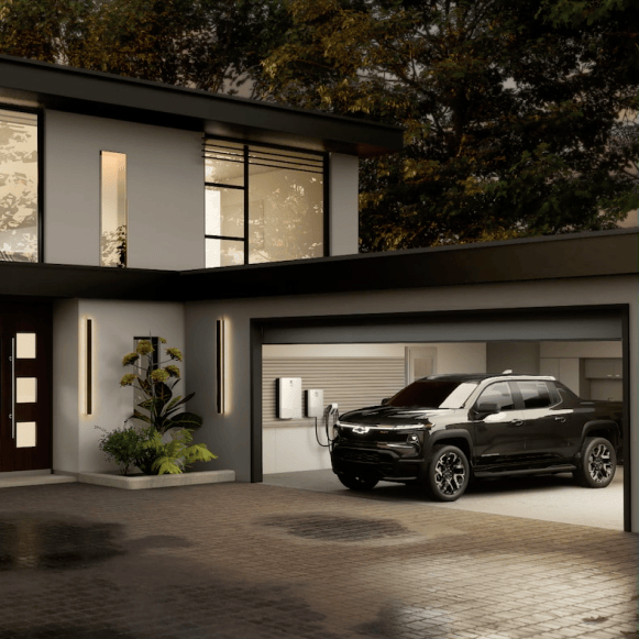 Chevy Silverado EV Charging in a Home Garage that is Powering Lights Within the Home