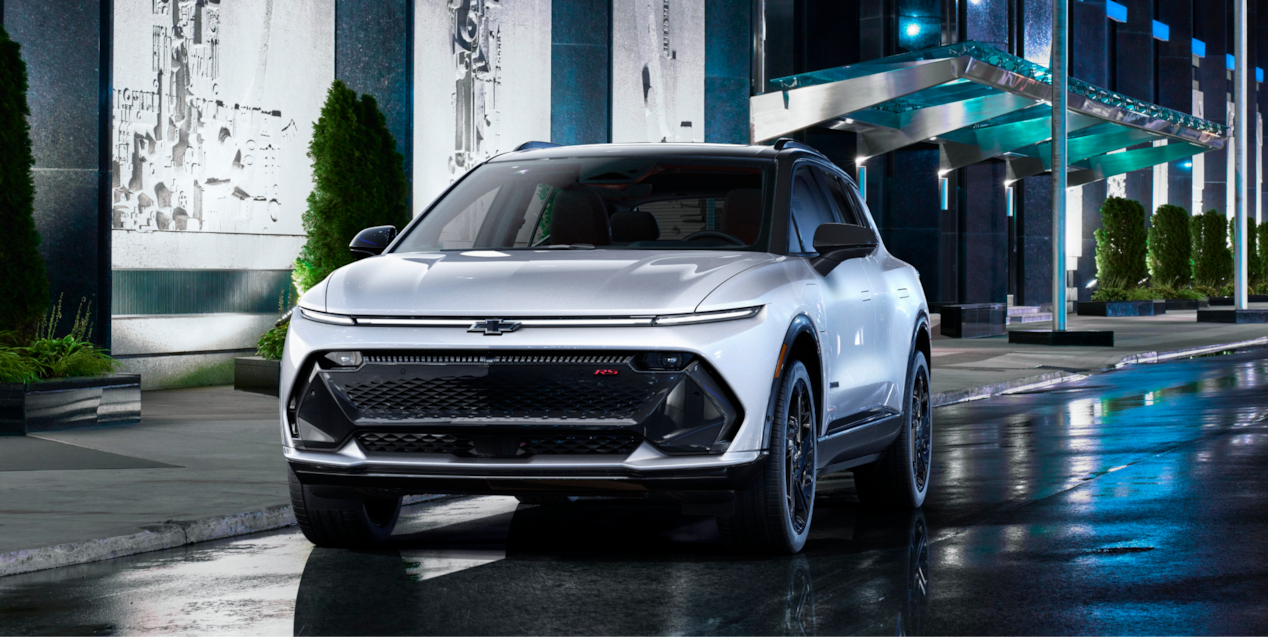 A Chevy Equinox EV Parked Outside a Hotel at Night