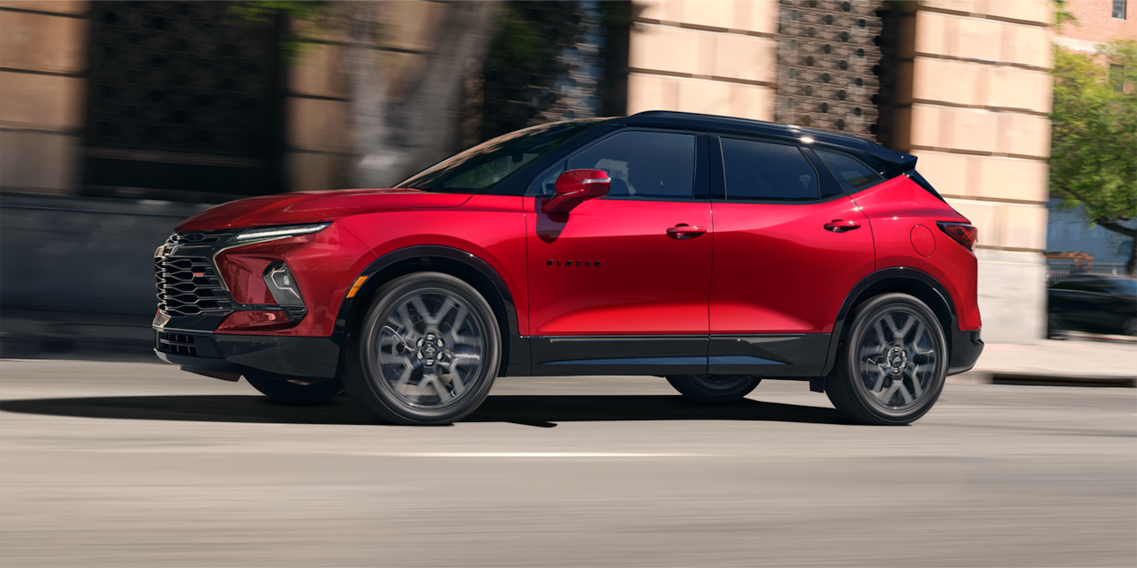 Red 2025 Chevy Blazer Driving Passed Store Fronts