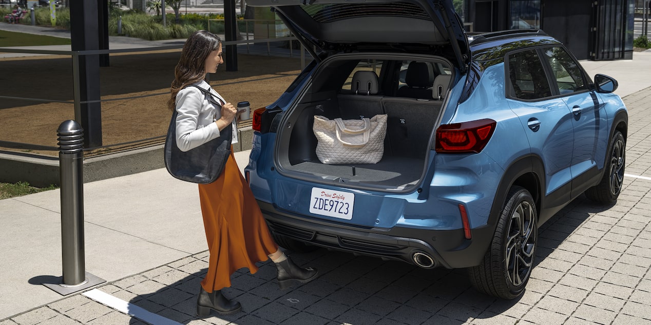 A Woman Loading Her Bag in the Trunk of the 2026 Chevy Trailblazer