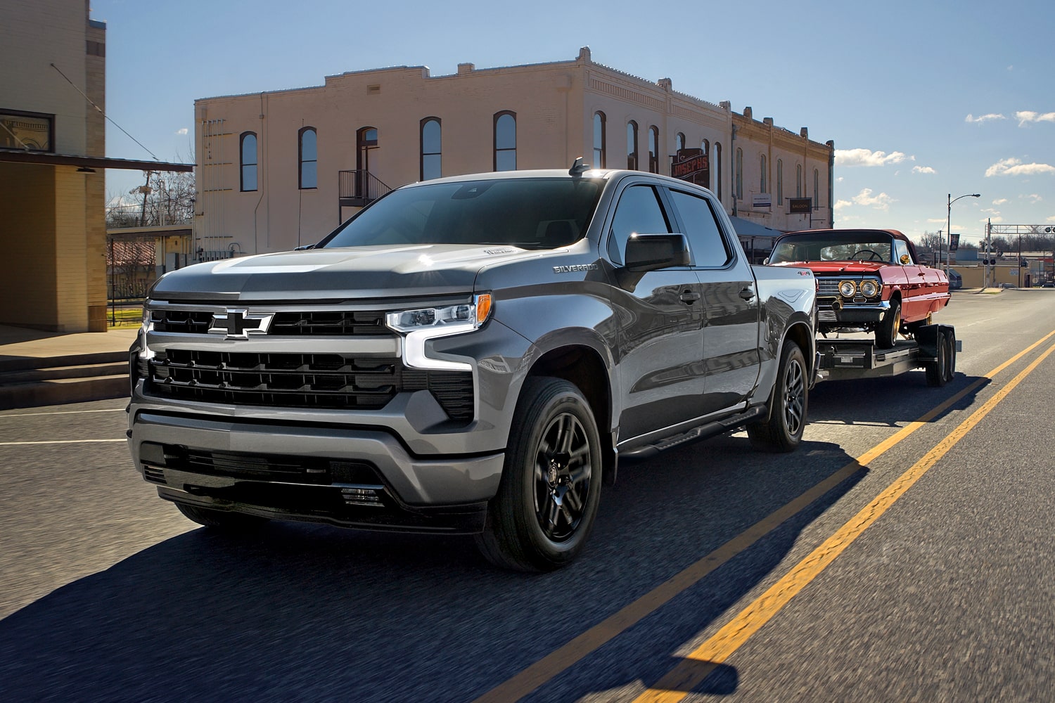 2026 Chevrolet Silverado LD driving on a city road.