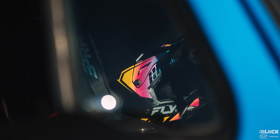 A Close-up of the Driver’s Helmet Seen through a Constraint View at It Gets Hit by Sunlight