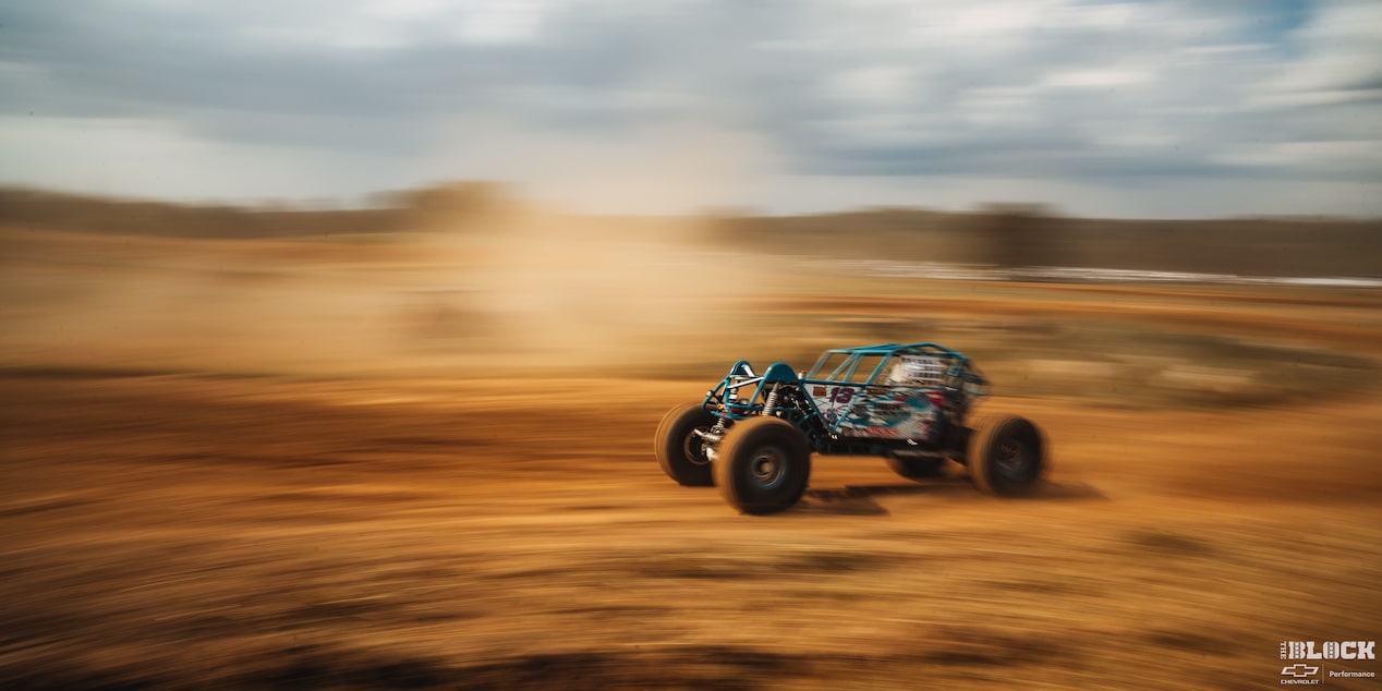 Side View of an Off-Road Vehicle Speeding Though a Trail