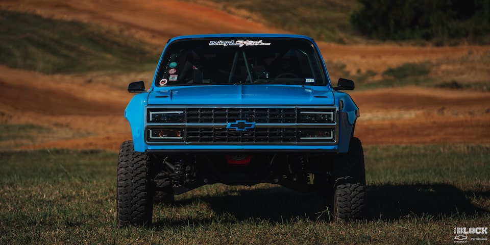 Front Eye Level View of a Blue Chevy Pickup Truck on a Grassy Plain